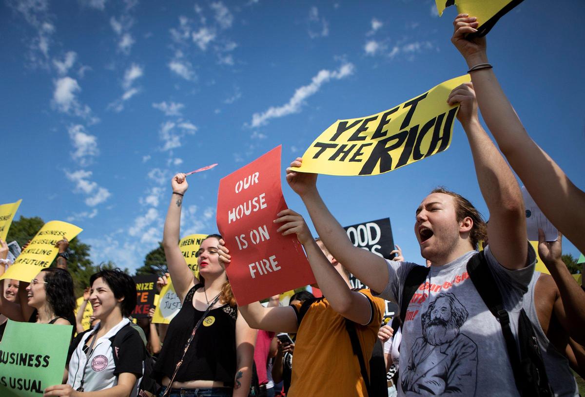 Samuel Vigliaturo, right, and others rally in Kansas City on Friday, Sept. 20, 2019, at Frank A. Theis Park. The local march and rally were part of the Global Climate Strike, which asks students and people across the world to step out of their classrooms and jobs to protest the various causes of the climate crisis.