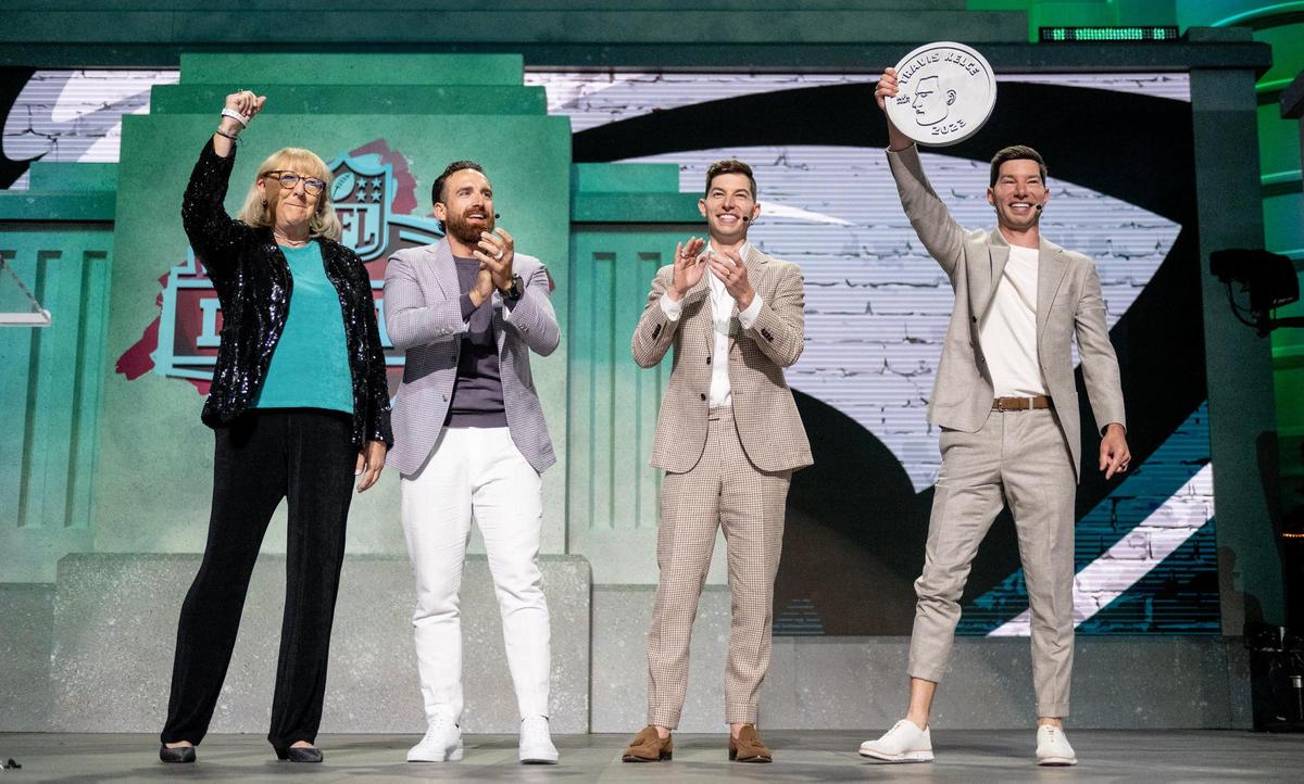 Donna Kelce, left, the mother of Chiefs tight end Travis Kelce, raises her fist after flipping a coin with the YouTube creators of Dude Perfect during the NFL Draft outside of Union Station on Thursday, April 27, 2023, in Kansas City.