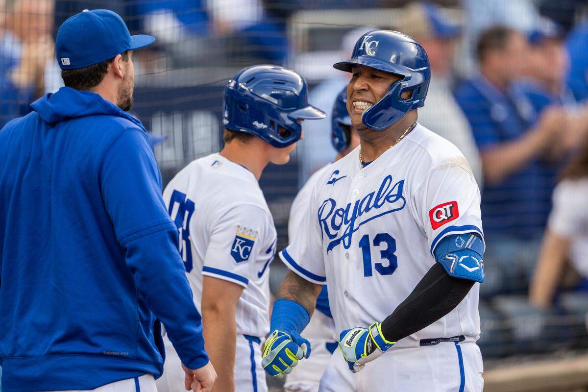 Kansas City Royals team captain Salvador Perez, right, flexes after hitting a home run against the Boston Red Sox on Wednesday, May 20, 2026, at Kauffman Stadium.