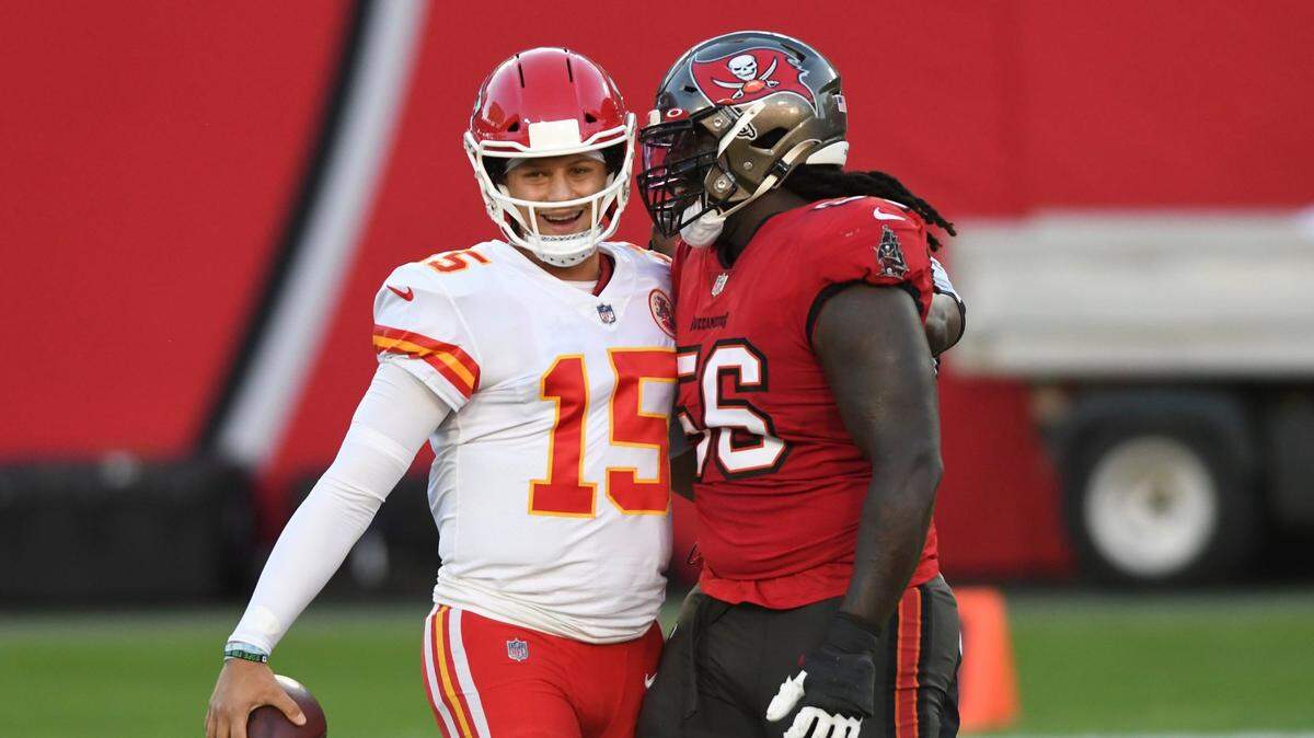 Kansas City Chiefs quarterback Patrick Mahomes, left, smiles while Buccaneers defensive tackle Rakeem Nunez-Roches, the former Chief, gets in his ear Sunday in Tampa.