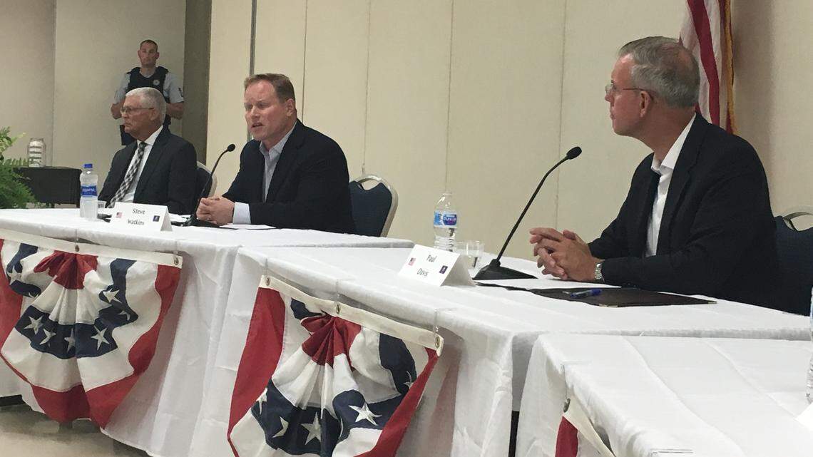 Republican Steve Watkins, middle, and Democrat Paul Davis, right, spoke at a forum in Independence Wednesday night.