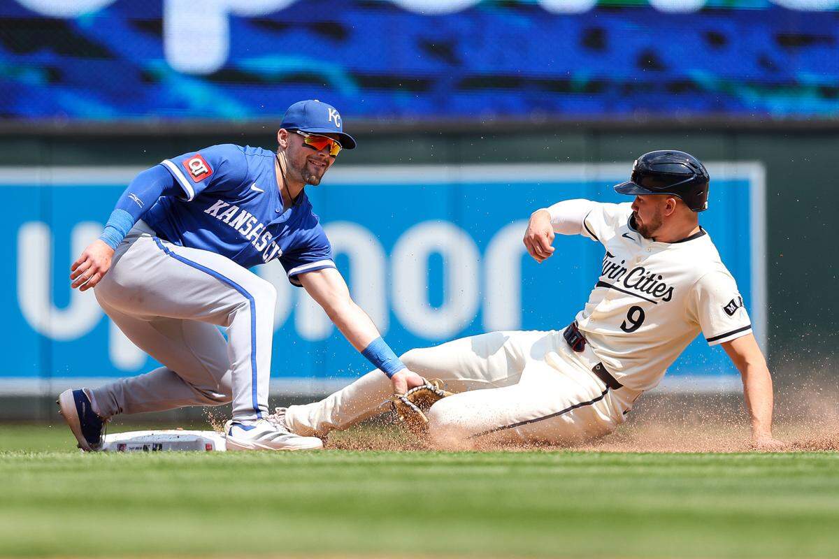 Kansas City Royals second baseman Michael Massey (19) tags out Minnesota Twins outfielder Trevor Larnach (9) on a steal attempt during the eighth inning at Target Field on May 25, 2025 in Minneapolis, Minnesota, USA.