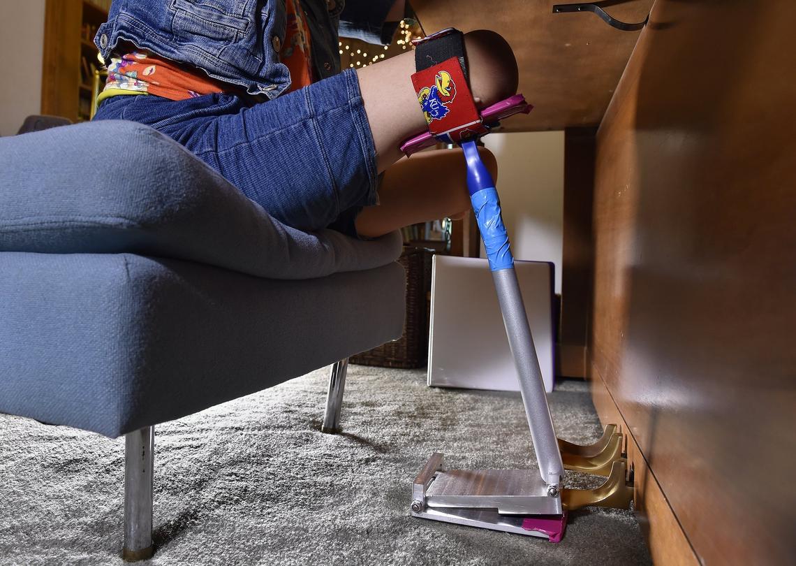 KU engineering students created a tool to let Heidi Burke push the piano pedal and create smooth harmonies. The top straps to her thigh. The bottom is coated in rubber so it does not slip.