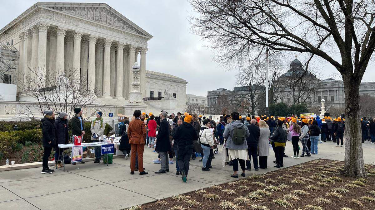 Demonstrators gather outside the U.S. Supreme Court on Feb. 28, 2023, ahead of oral arguments in the lawsuit against President Joe Biden’s student debt forgiveness plan.