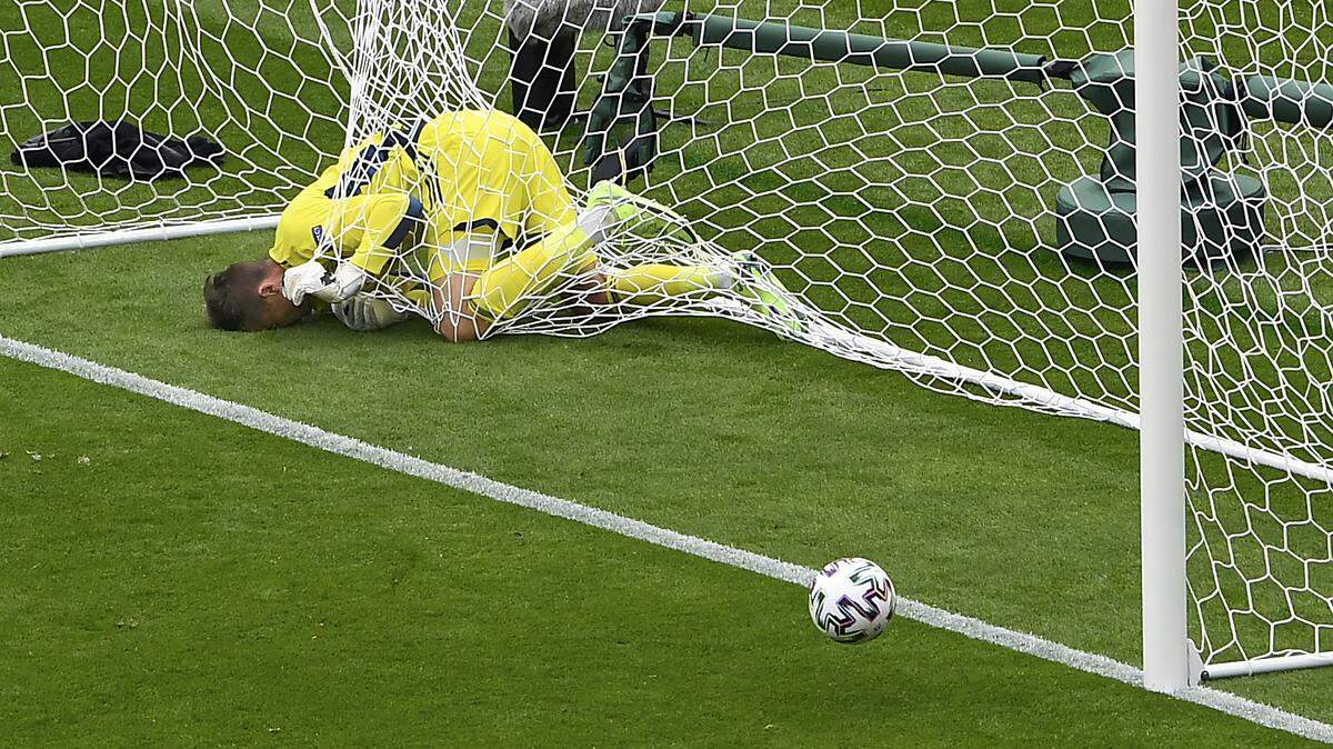 Scotland’s goalkeeper David Marshall is caught in the goal’s net after he failed to save a long distance shot by Czech Republic’s Patrik Schick during the Euro 2020 soccer championship group D match between Scotland and Czech Republic at Hampden Park stadium in Glasgow, Monday, June 14, 2021. (AP Photo/Andy Buchanan, Pool)