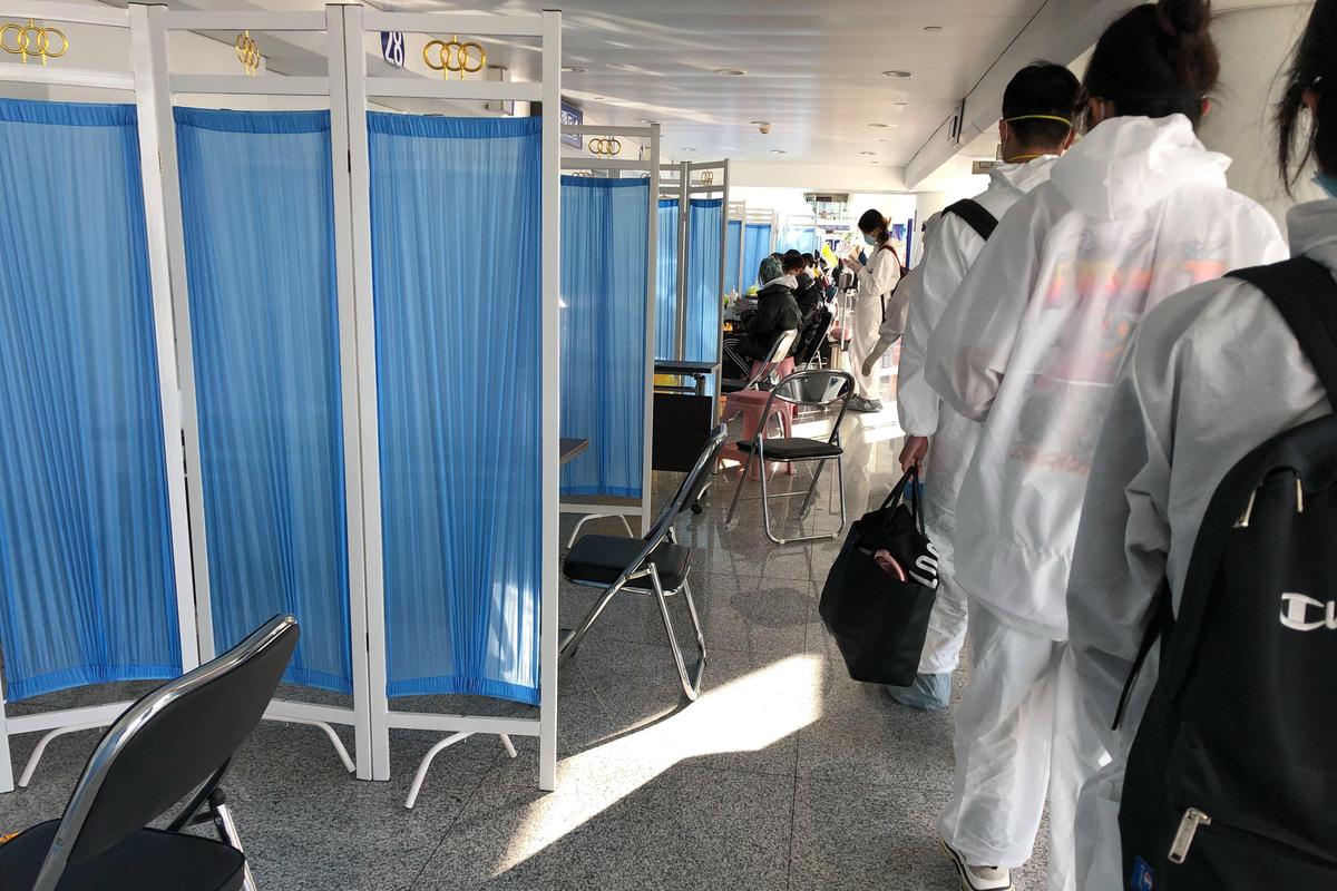 Blue medical curtains were placed inside the Hohhot airport, where staff could screen international passengers for health and travel history.