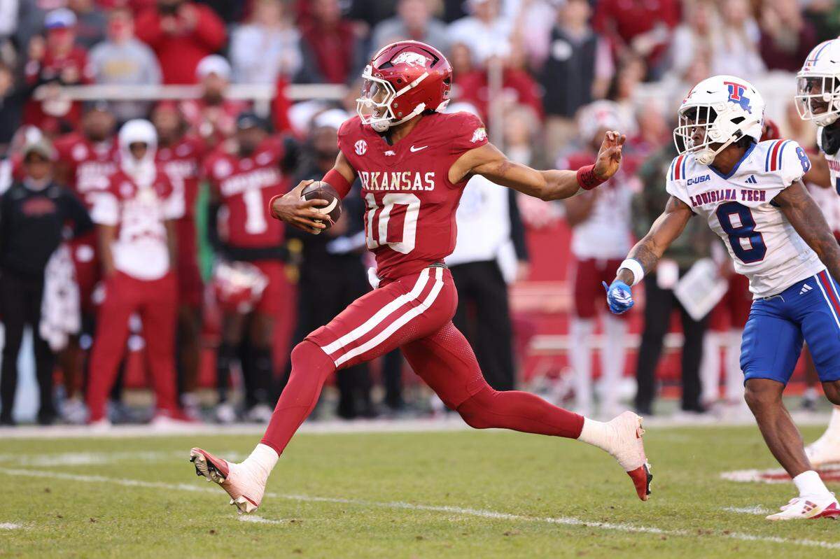 Arkansas Razorbacks quarterback Taylen Green, left, runs for a touchdown against the Louisiana Tech Bulldogs during a Saturday, Nov 23, 2024 college football game at Donald W. Reynolds Razorback Stadium in Fayetteville, Arkansas.