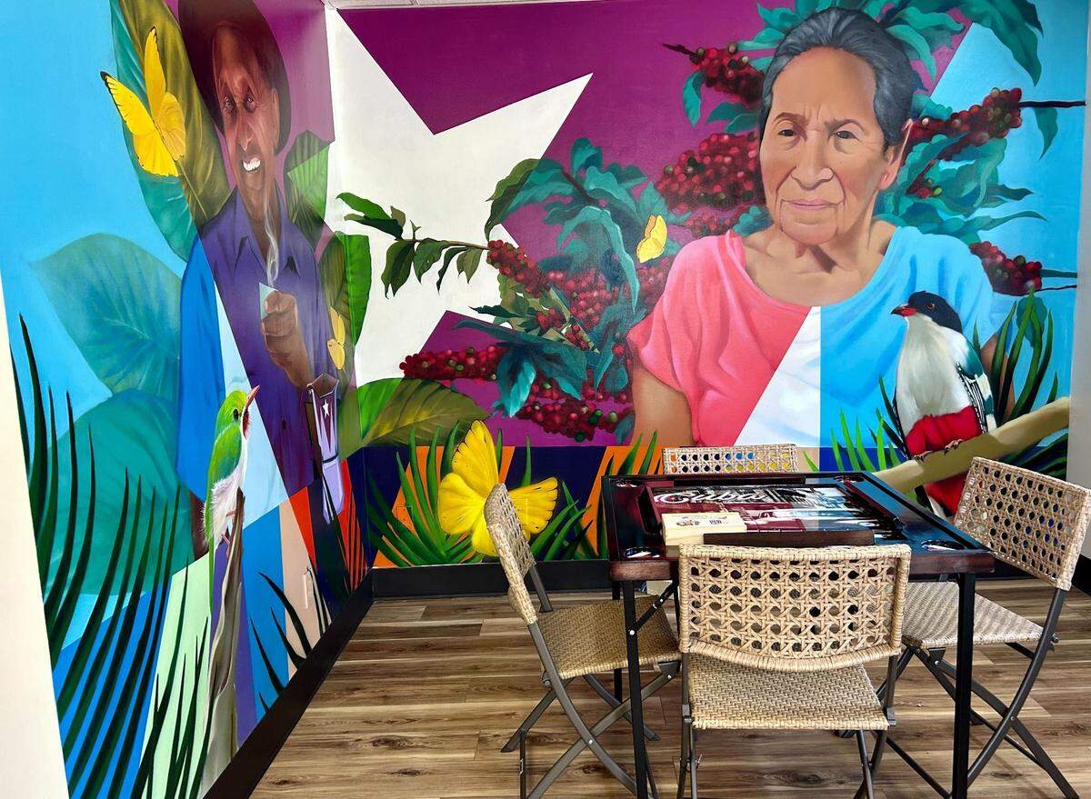 A painting of Karell Martinez’s grandmother watches over his new cafe.