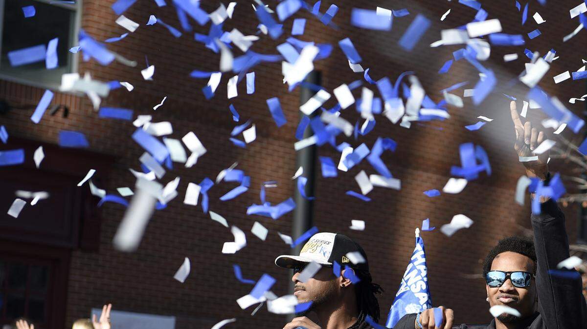Yordano Ventura waves to the crowd from the victory parade for the World Series.