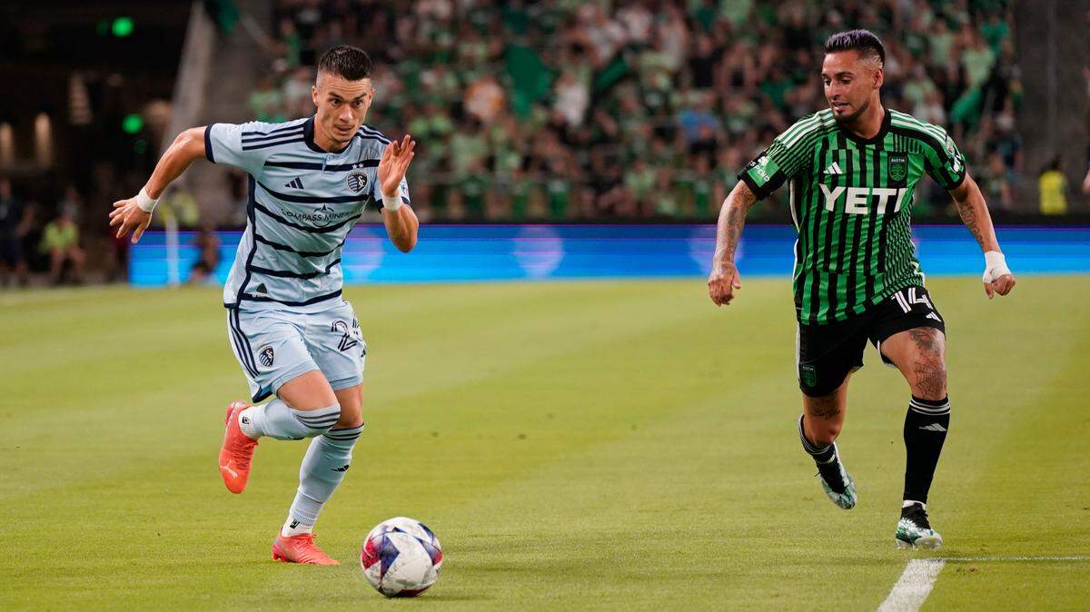 Sporting Kansas City midfielder Erik Thommy (26) is defended by Austin FC forward Diego Fagundez (14) in the first half at Q2 Stadium in Austin, Texas, on July 15, 2023.