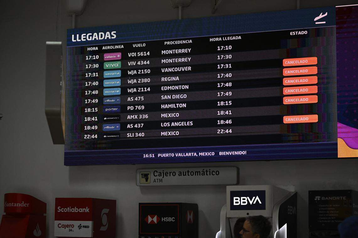 A screen showing canceled flights is seen at Licenciado Gustavo Diaz Ordaz International Airport in Puerto Vallarta, Jalisco state, Mexico, on February 23, 2026.