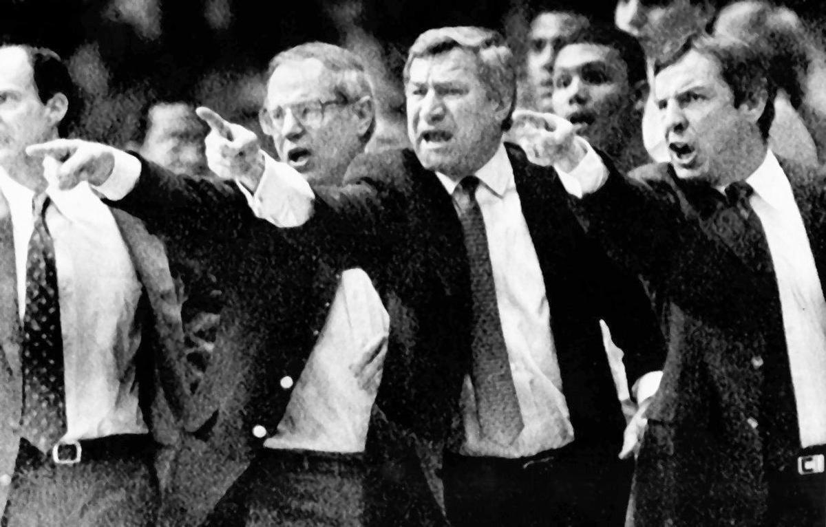 Three coaches with Kansas connections ended up at North Carolina. Dean Smith (center), played at KU. Bill Guthridge (left), a native of Parson, Kan., took over from Smith. Roy Williams (right), left the Jayhawks for the Tar Heels. The three shared a coaching moment during a North Carolina game in 1998.
