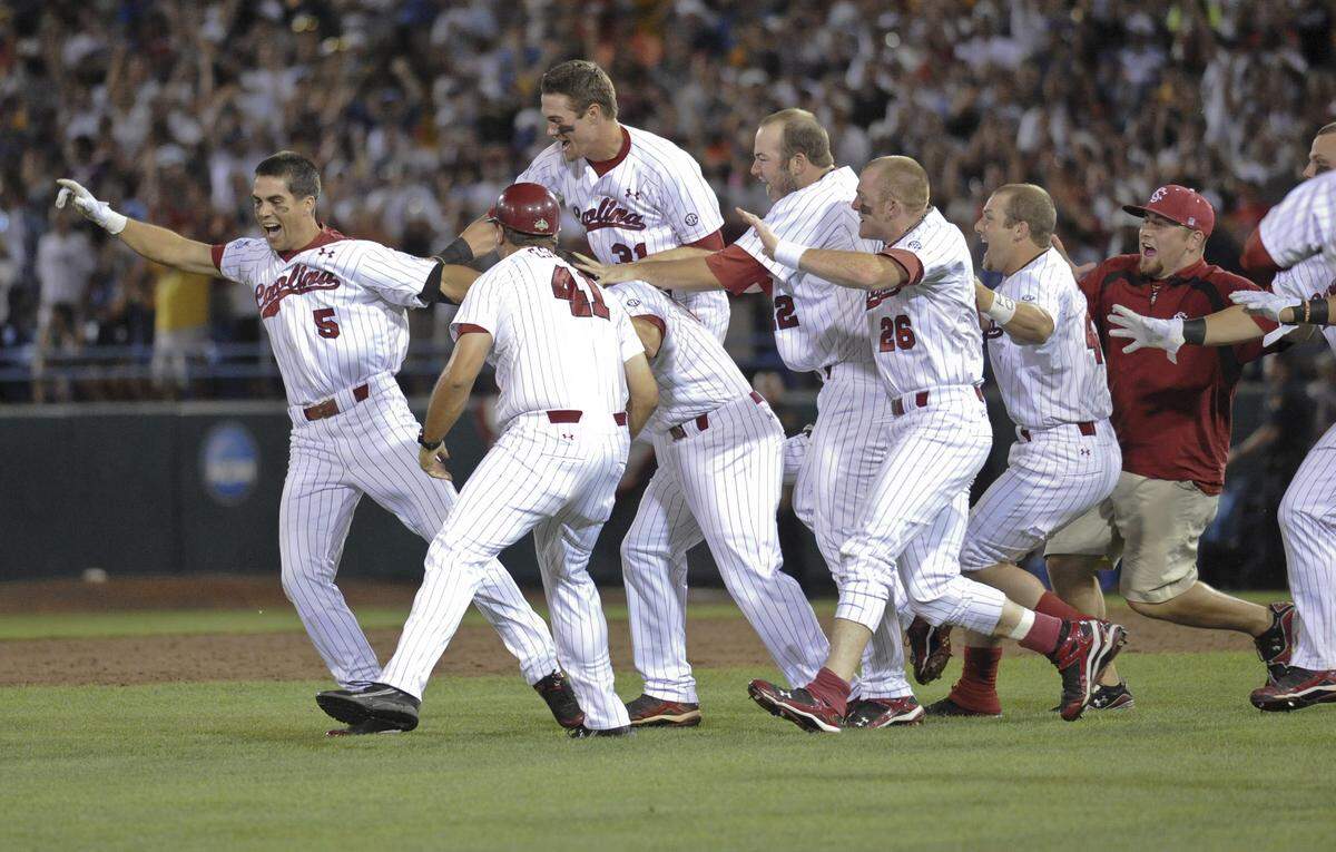 South Carolina players celebrate with Whit Merrifield, left, whose single in the 11th inning drove in the winning run by Scott Wingo in game two of the best-of-three NCAA College World Series baseball finals, in Omaha, Neb., Tuesday, June 29, 2010. South Carolina beat UCLA 2-1 in 11 innings to win the championship.(AP Photo/Dave Weaver)