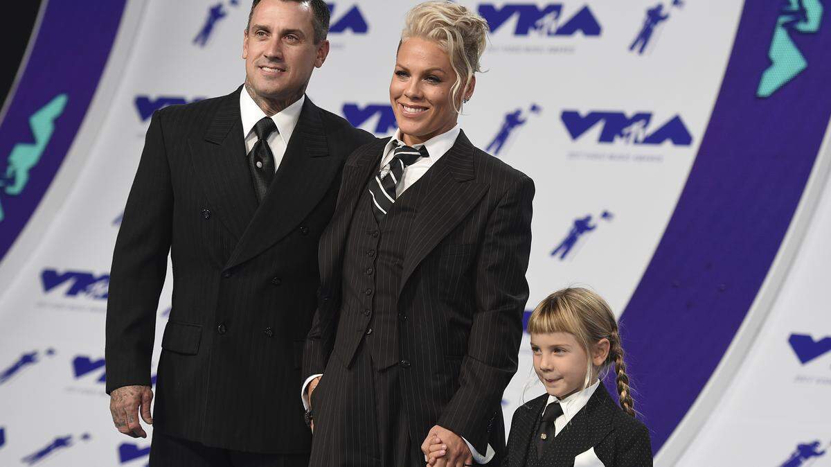 Pink, center, Carey Hart, left, and their daughter Willow in 2017. Hart posted a video of Willow shooting a rifle that has stirred debate.