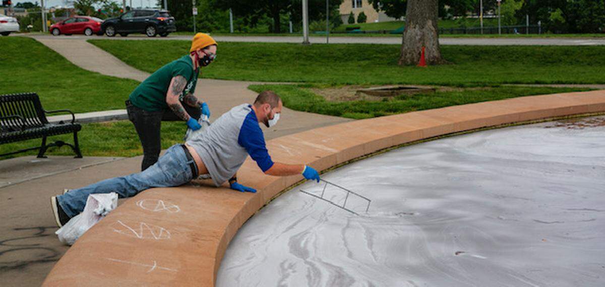 Some demonstrators returned to the Country Club Plaza Sunday to clean up trash. The protests Saturday night led to many arrests and some property damage.