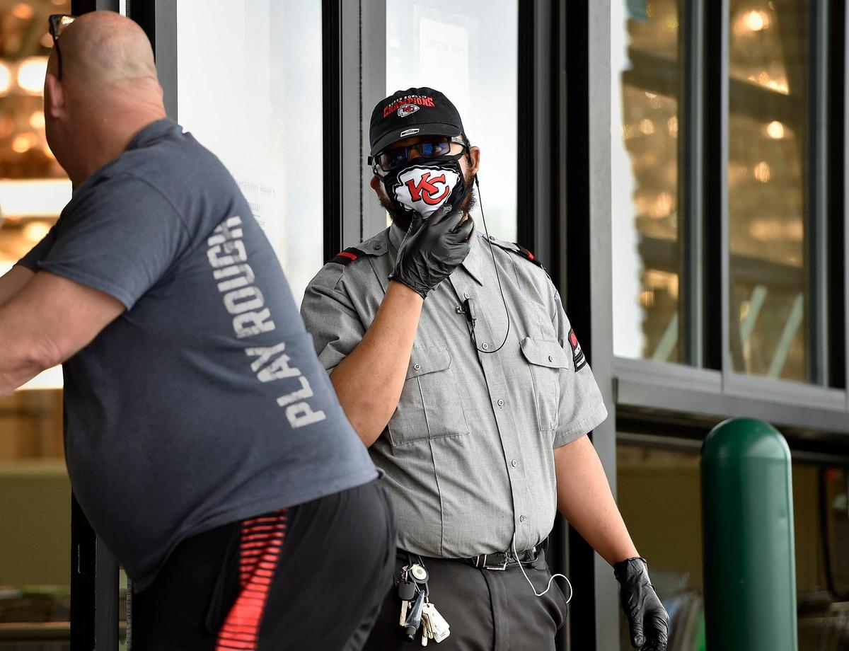 Security guard Keith Maxey Jr. informed a customer entering the Menards store in Kansas City, North that the store requires customers to wear masks. If customers don’t have one of their own, they can purchase one inside the door.