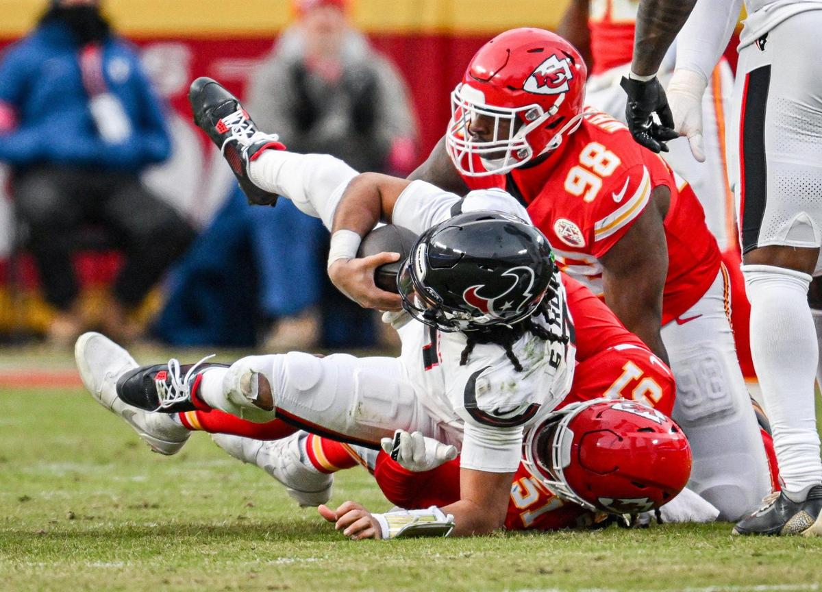 Kansas City Chiefs defensive tackle Tershawn Wharton (98) and defensive end Mike Danna (51) sack Houston Texans quarterback C.J. Stroud (7) in the second quarter during the AFC Divisional Round playoff game on Saturday, Jan. 18, 2025, at GEHA Field at Arrowhead Stadium.