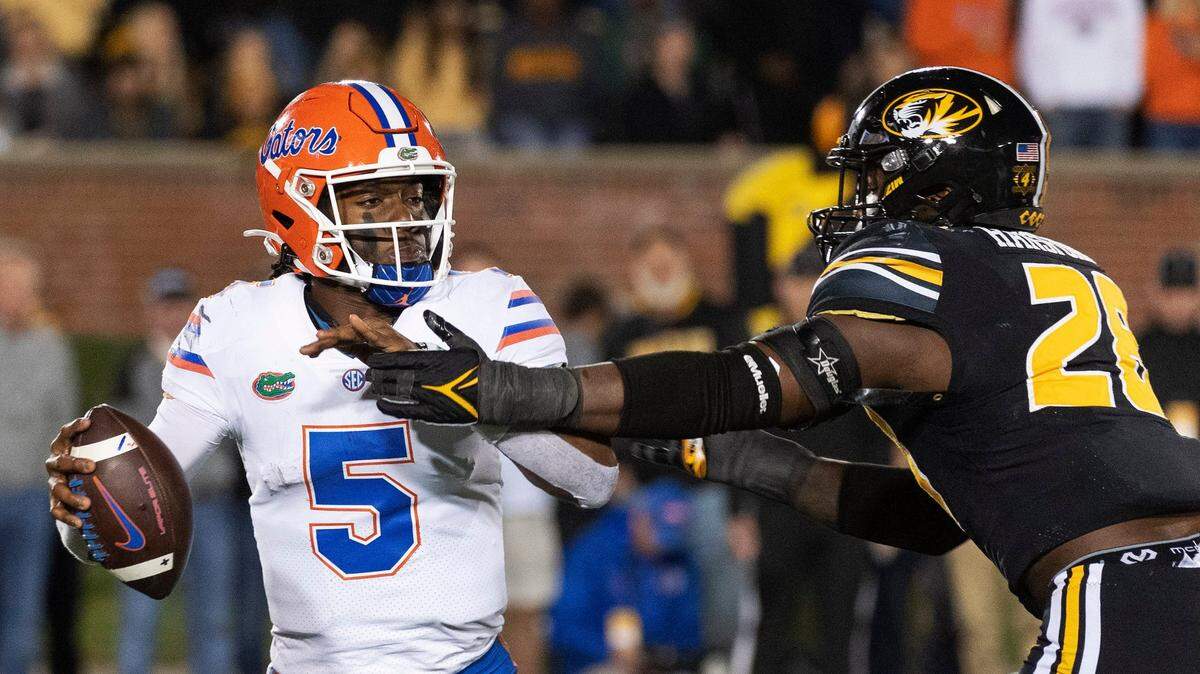 Florida quarterback Emory Jones, left, is sacked by Missouri defensive lineman Jatorian Hansford, right, during the fourth quarter of an NCAA college football game Saturday, Nov. 20, 2021, in Columbia, Mo. (AP Photo/L.G. Patterson)
