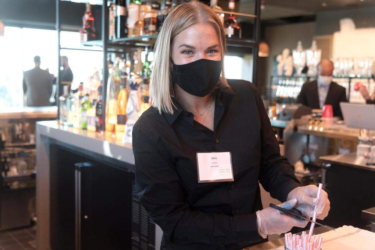 Beverage server Sara Johnston preps the bar at Prime Social, set to open Tuesday.
