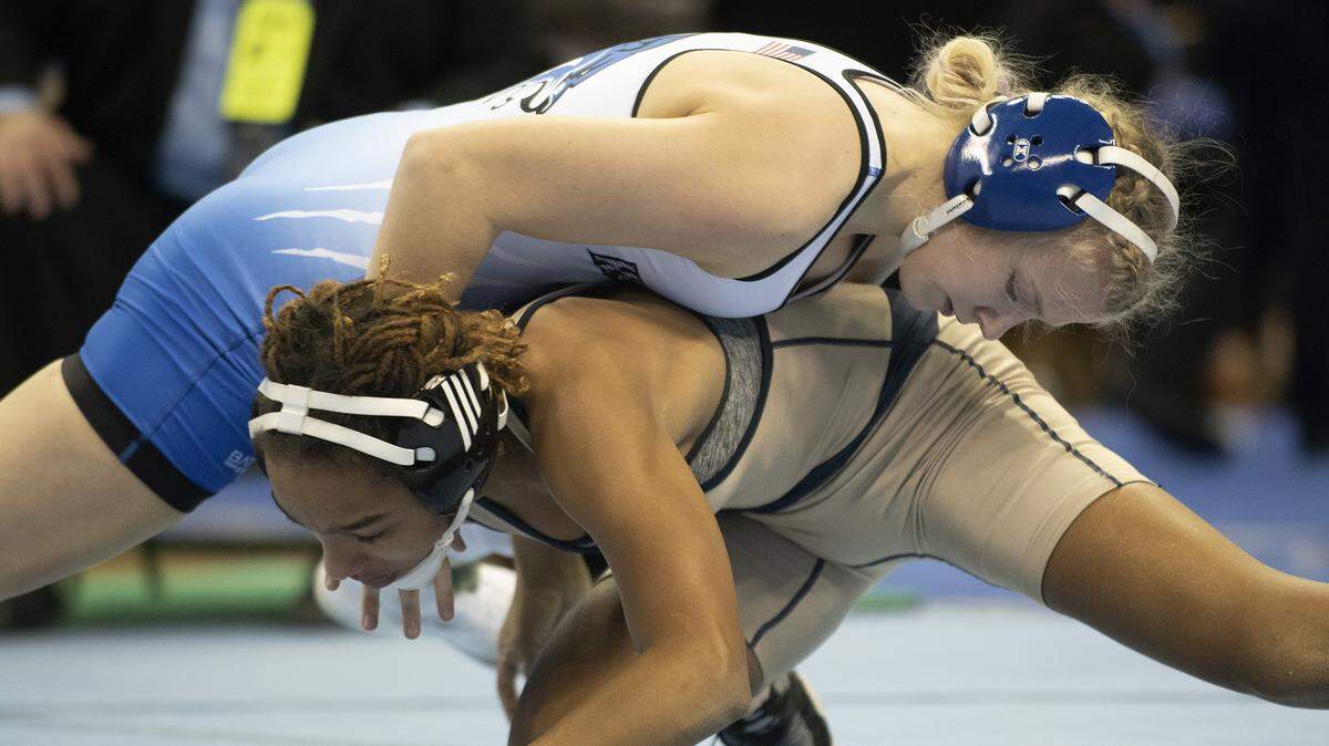 Harrisonville’s Nonnie Justice takes down Holt’s Maria Slaughter during the MSHSAA State Wrestling Championships on Saturday in Columbia. She won a state title in the competition.