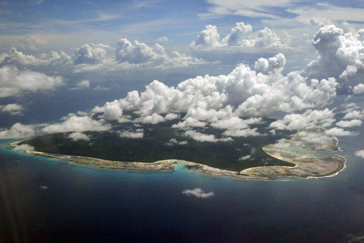 FILE – In this Nov. 14, 2005 file photo, clouds hang over the North Sentinel Island, in India’s southeastern Andaman and Nicobar Islands. An American is believed to have been killed by an isolated Indian island tribe known to fire at outsiders with bows and arrows, Indian police said Wednesday, Nov. 21, 2018. Police officer Vijay Singh said seven fishermen have been arrested for facilitating the American’s visit to North Sentinel Island, where the killing apparently occurred. Visits to the island are heavily restricted by the government. (AP Photo/Gautam Singh, File)