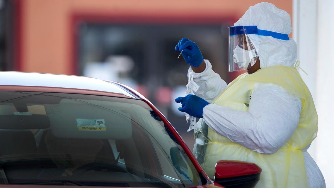 A Kansas City Health Department worker tests a resident for COVID-19 during an event last year. Following a letter from Attorney General Eric Schmitt, several health departments in rural Missouri counties have halted their COVID-19 response work.