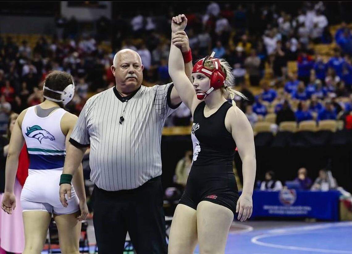 Former Fort Osage wrestler Haley Ward is declared the winner during a match.