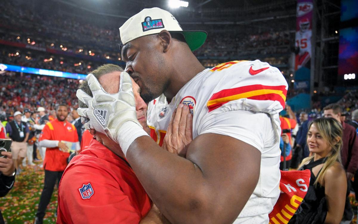 Chiefs defensive tackle Chris Jones kisses defensive coordinator Steve Spagnuolo on the head after Kansas City’s Super Bowl LVII victory over the Philadelphia Eagles in February 2023.