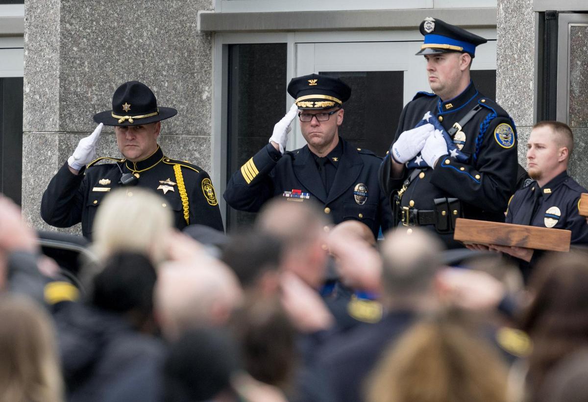 Independence Police Chief Adam Dustman salutes the casket of police officer Cody Allen on Friday, March 8, 2024, in Independence. Allen was fatally shot during an eviction in northeast Independence last week.