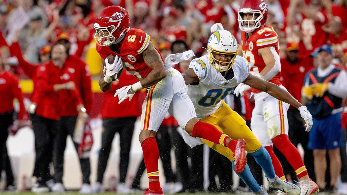 Kansas City Chiefs safety Bryan Cook (6) intercepts a pass intended for Los Angeles Chargers tight end Donald Parham Jr. (89) during an NFL football game at GEHA Field at Arrowhead Stadium on Sunday, Oct. 22, 2023, in Kansas City.
