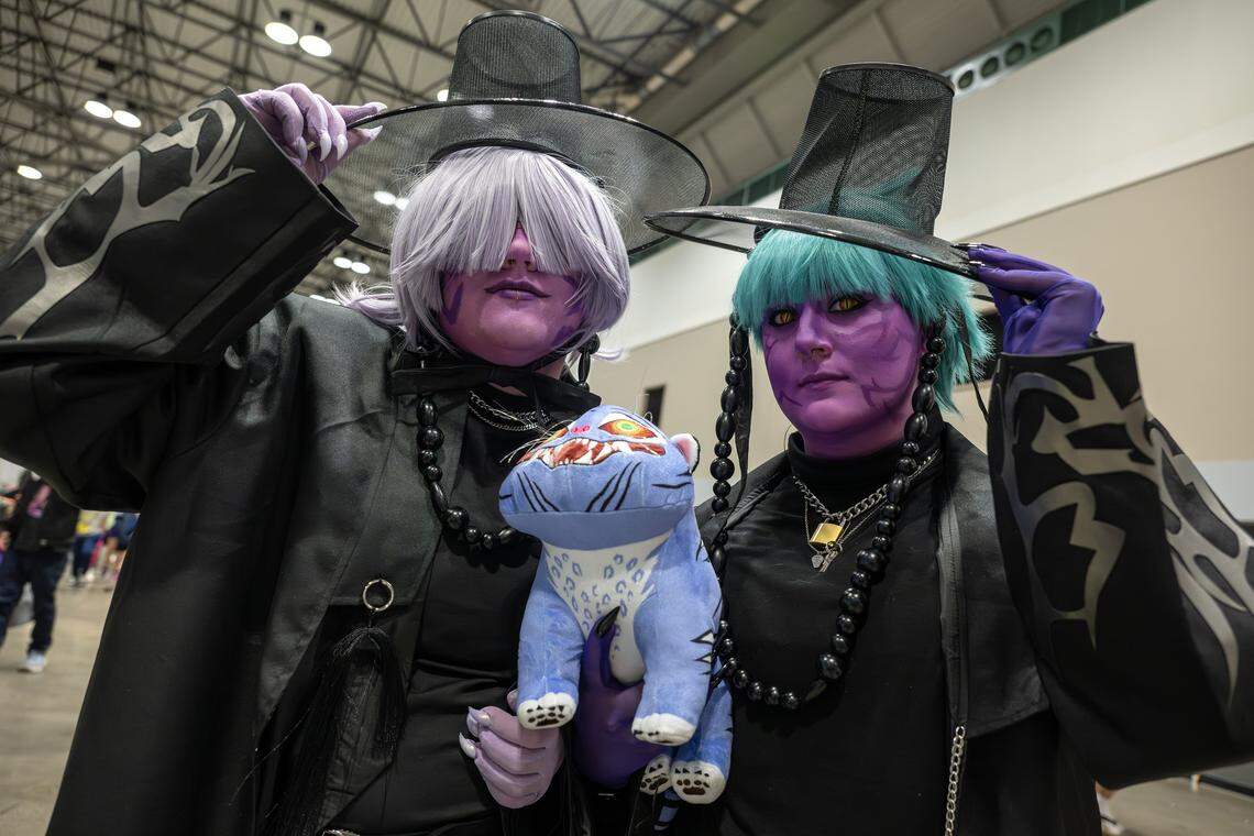 Kai Pugh, left, and Ez McLaughlin cosplay as characters from the movie “K-Pop Demon Hunters” during Planet Anime at the Kansas City Convention Center on Saturday, Nov. 22.