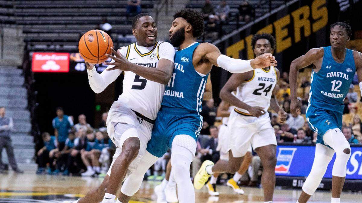 Missouri’s D’Moi Hodge drives past Coastal Carolina’s Jomaru Brown during the second half on Nov. 23, 2022, in Columbia. Missouri won 89-51.