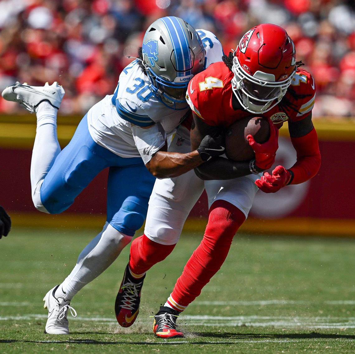 Kansas City Chiefs wide receiver Rashee Rice (4) is wrapped up by Detroit Lions cornerback Khalil Dorsey (30) Saturday in the first quarter.