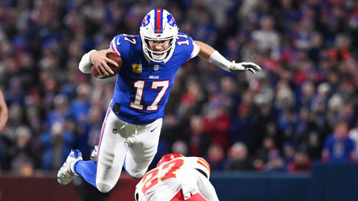 Buffalo Bills quarterback Josh Allen leaps over Kansas City Chiefs safety Chamarri Conner en route to a first down during a Week 11 NFL game at Highmark Stadium in Orchard Park, New York, on Sunday, Nov. 17, 2024.
