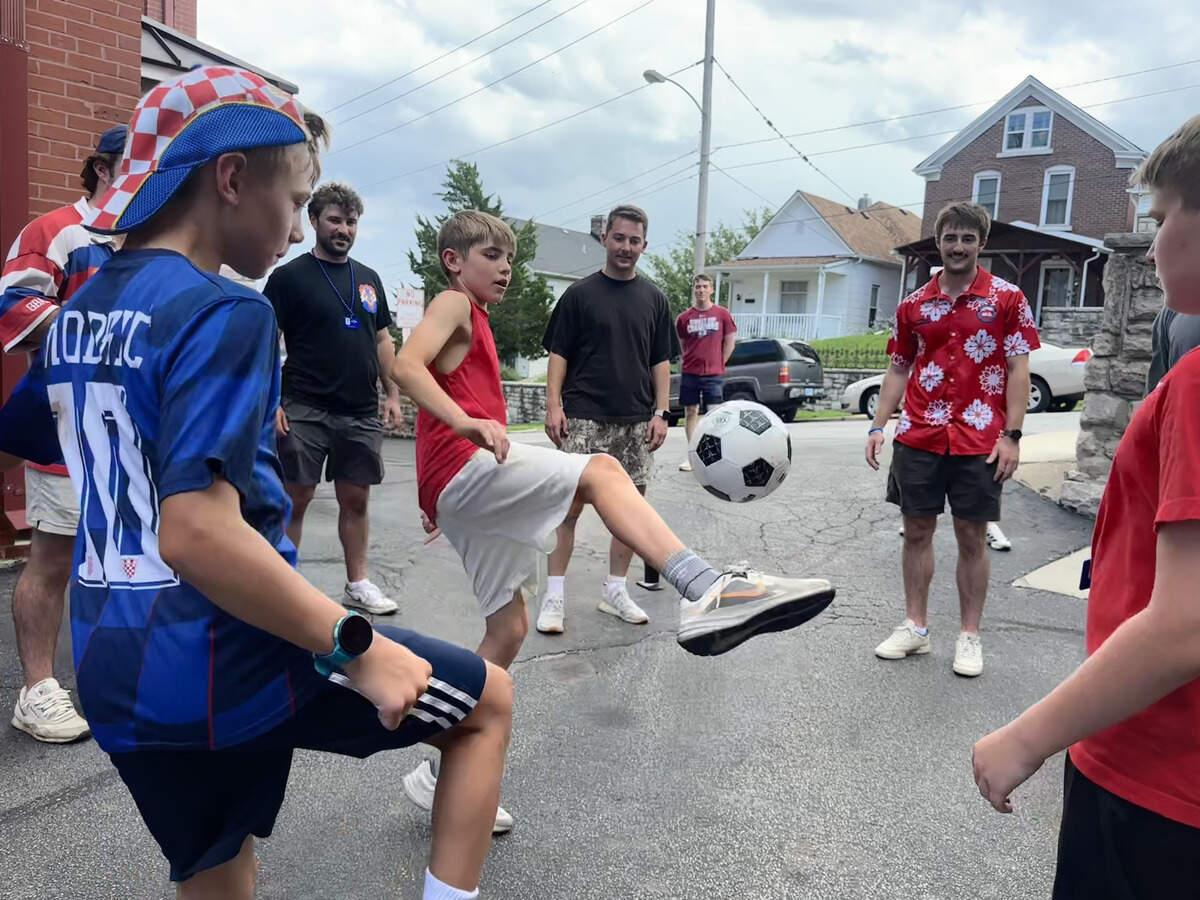 Kids play soccer during half time.