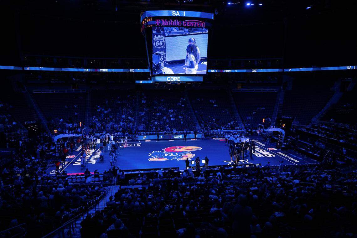 The basketball court lights up in a blue hue during Kansas Jayhawks player introductions before the Big 12 Women's Basketball Tournament at T-Mobile Center on Wednesday, March 4, 2026, in Kansas City.