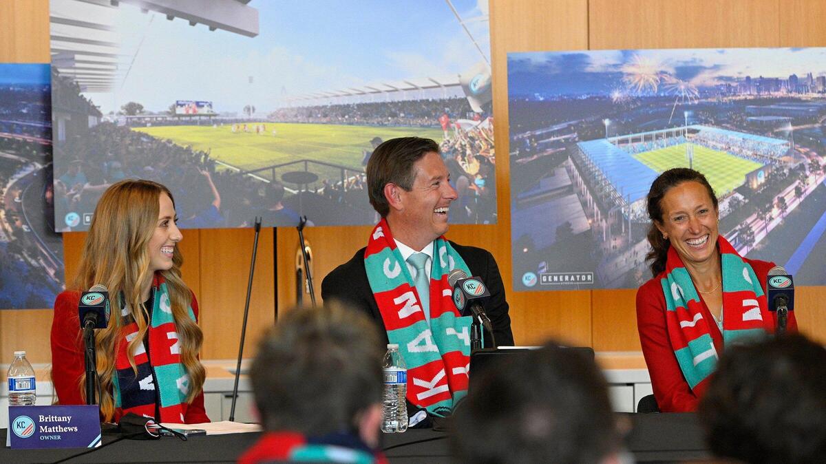KC Current co-owners Brittany Matthews, from left, and Chris and Angie Long react to comments by Mayor Quinton Lucas during a news conference held last year to announce plans to develop a new soccer-specific stadium at Berkley Riverfront Park.