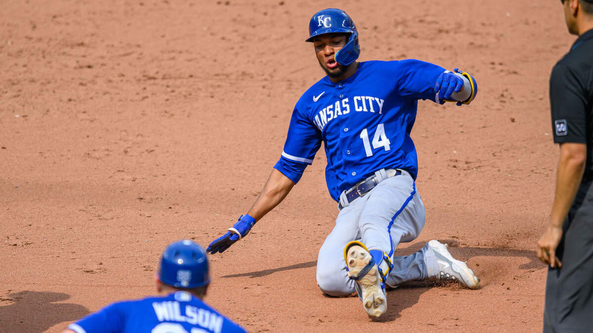 Kansas City Royals left fielder Edward Olivares (14) slides into third base after hitting a triple during the ninth inning against the Baltimore Orioles at Oriole Park at Camden Yards on June 11, 2023.