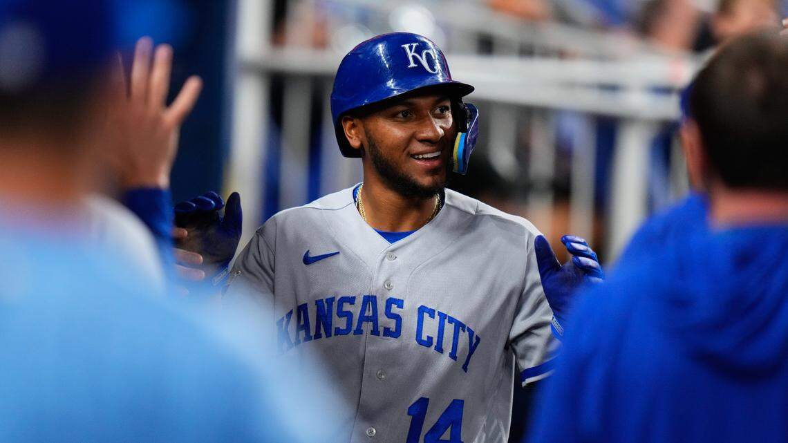 Kansas City Royals outfielder Edward Olivares (14) celebrates with teammates after scoring against the Miami Marlins during the eighth inning at loanDepot Park on June 5, 2023.