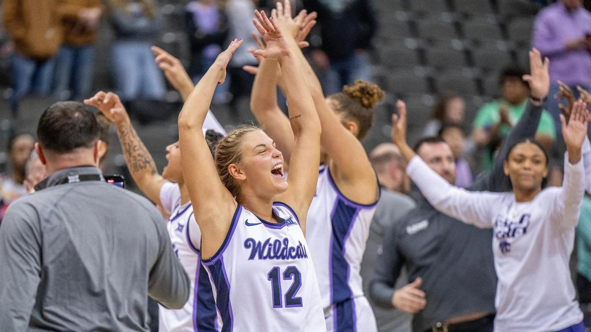 Kansas State Wildcats guard Gabby Gregory (12) celebrates with teammates after defeating the West Virginia Mountaineers 65-62 in a Big 12 Tournament NCAA women’s basketball game at T-Mobile Center on Saturday, March 9, 2024, in Kansas City.