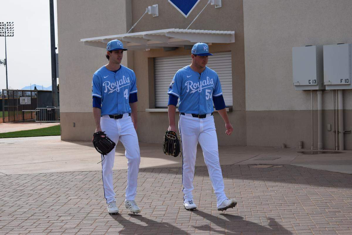 Kansas City Royals pitchers Daniel Lynch IV (left) and Austin Cox (right) walk to their next workout at the Royals spring training complex in Surprise, Arizona on Feb. 16, 2025.