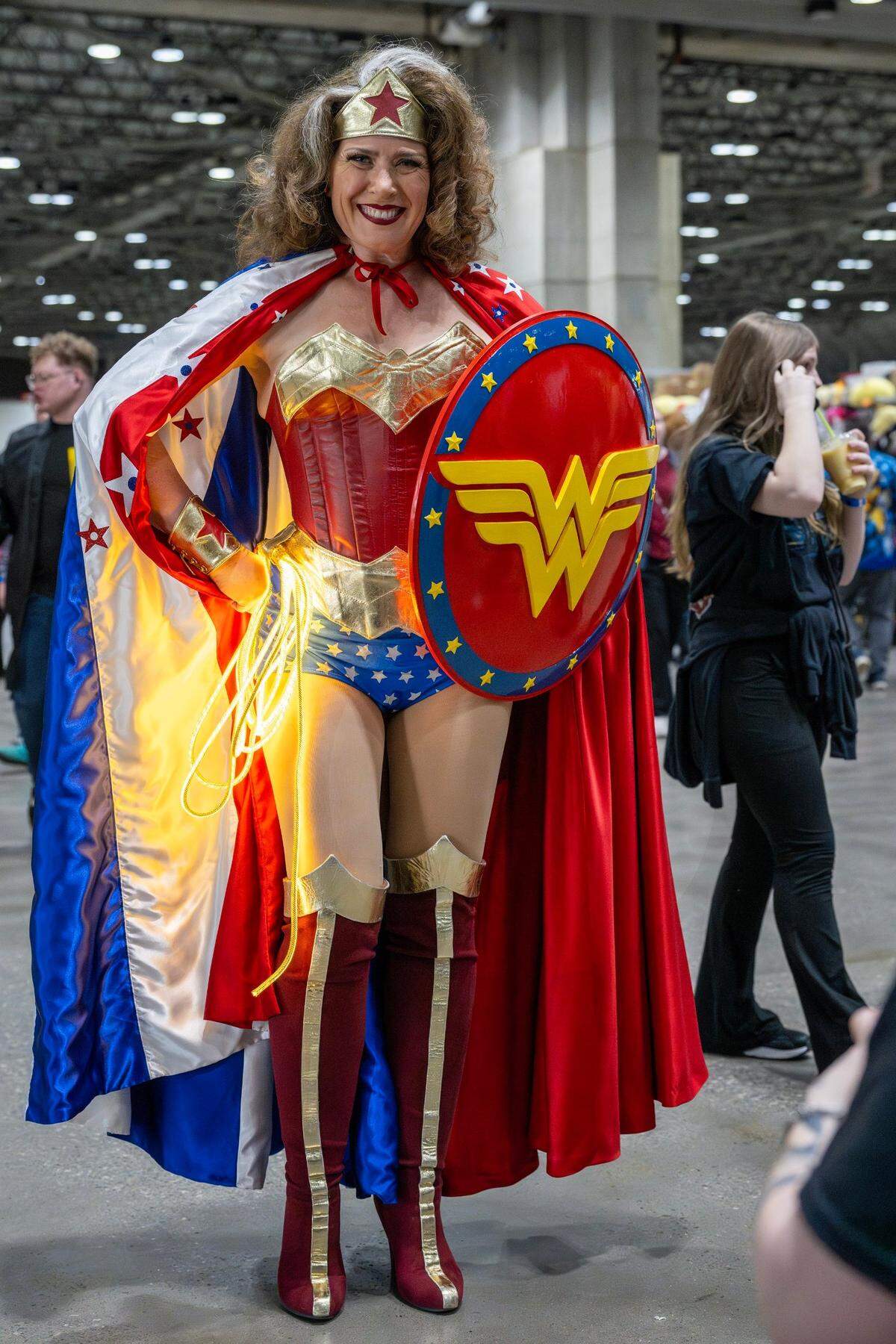 Katie Lockwood cosplays as Wonder Woman during Planet Comicon at the Kansas City Convention Center on Friday, March 21, 2025.