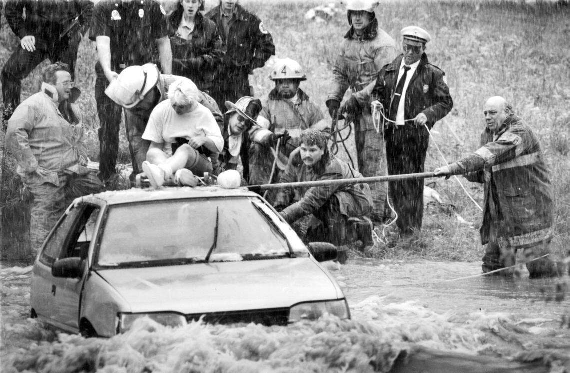 This scene wasn’t so unusual in the summer of 1993. Renee Barber’s short trip to her apartment became a long afternoon of fear as her car was trapped by floodwaters that rushed over Daggett Road in Kansas City North. Firefighters used a ladder to rescue her.