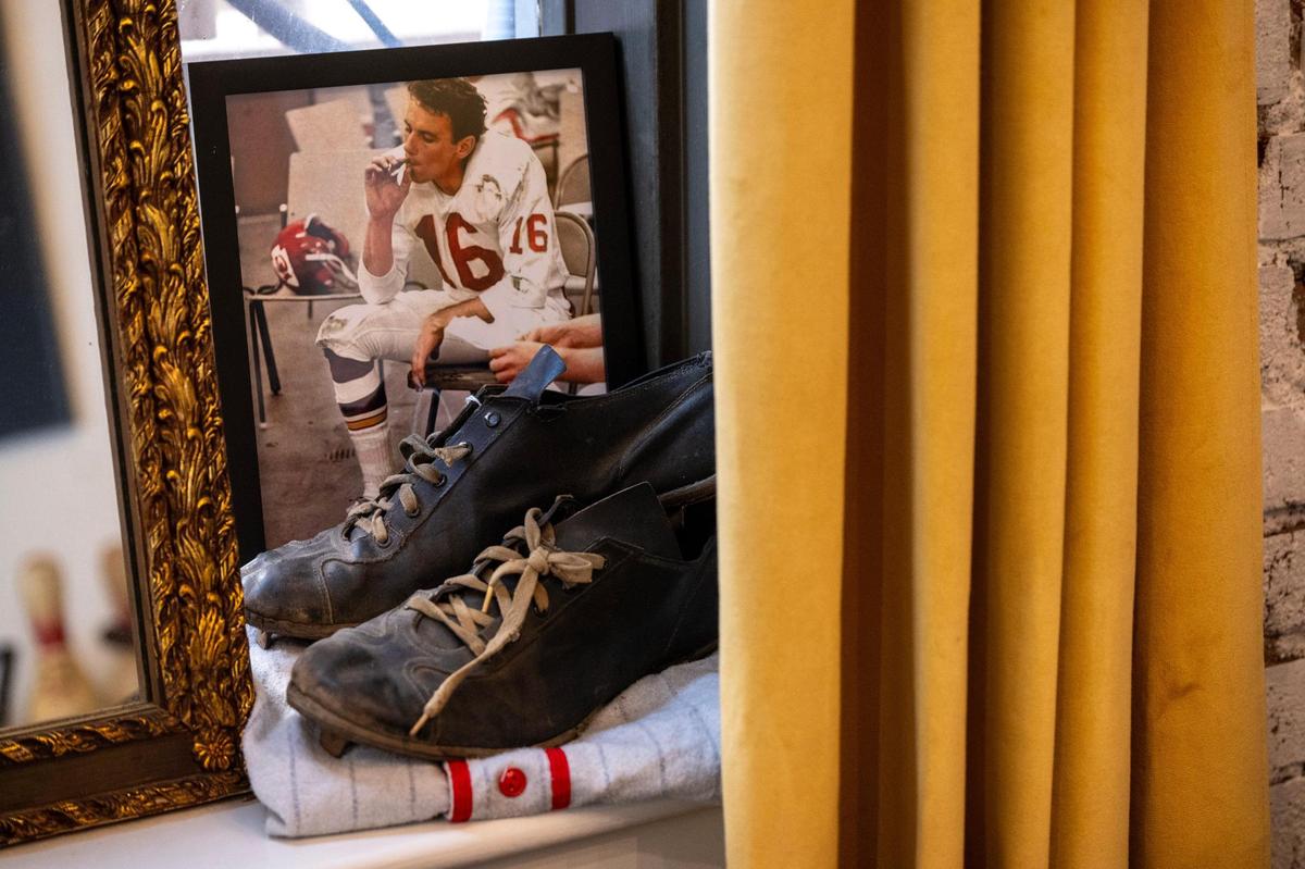 A vintage photograph of Kansas City Chiefs quarterback Len Dawson is on display at Le Champion.