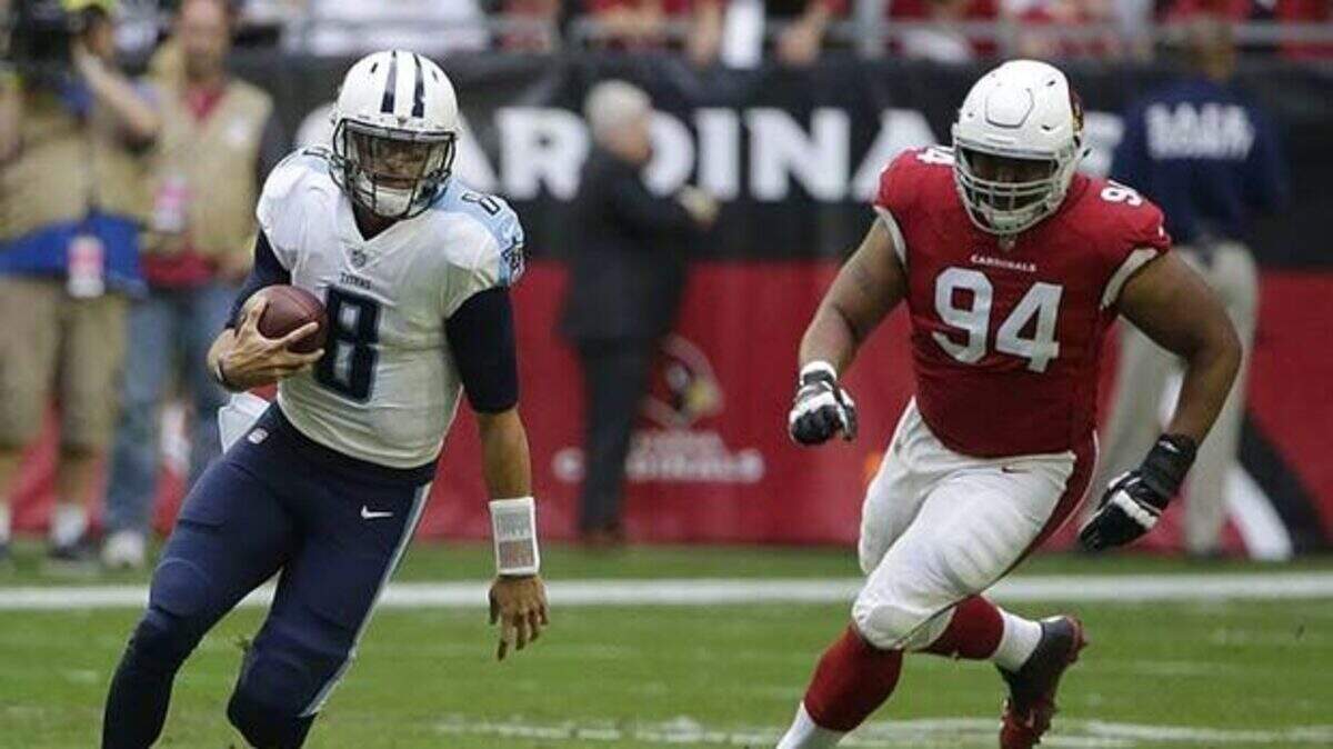 Xavier Williams (right) was with the Cardinals when he tried to chase down Titans quarterback Marcus Mariota during a game last season. The Chiefs are hoping that the addition of Williams at nose tackle will give a boost to the run defense.