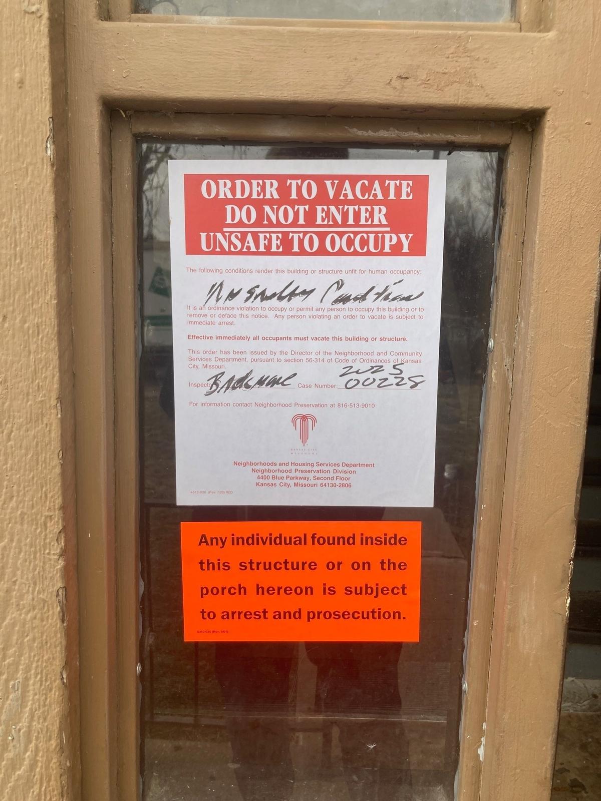 Warnings posted on the doors of the Cloverleaf Apartments declaring them “Unsafe to Occupy”