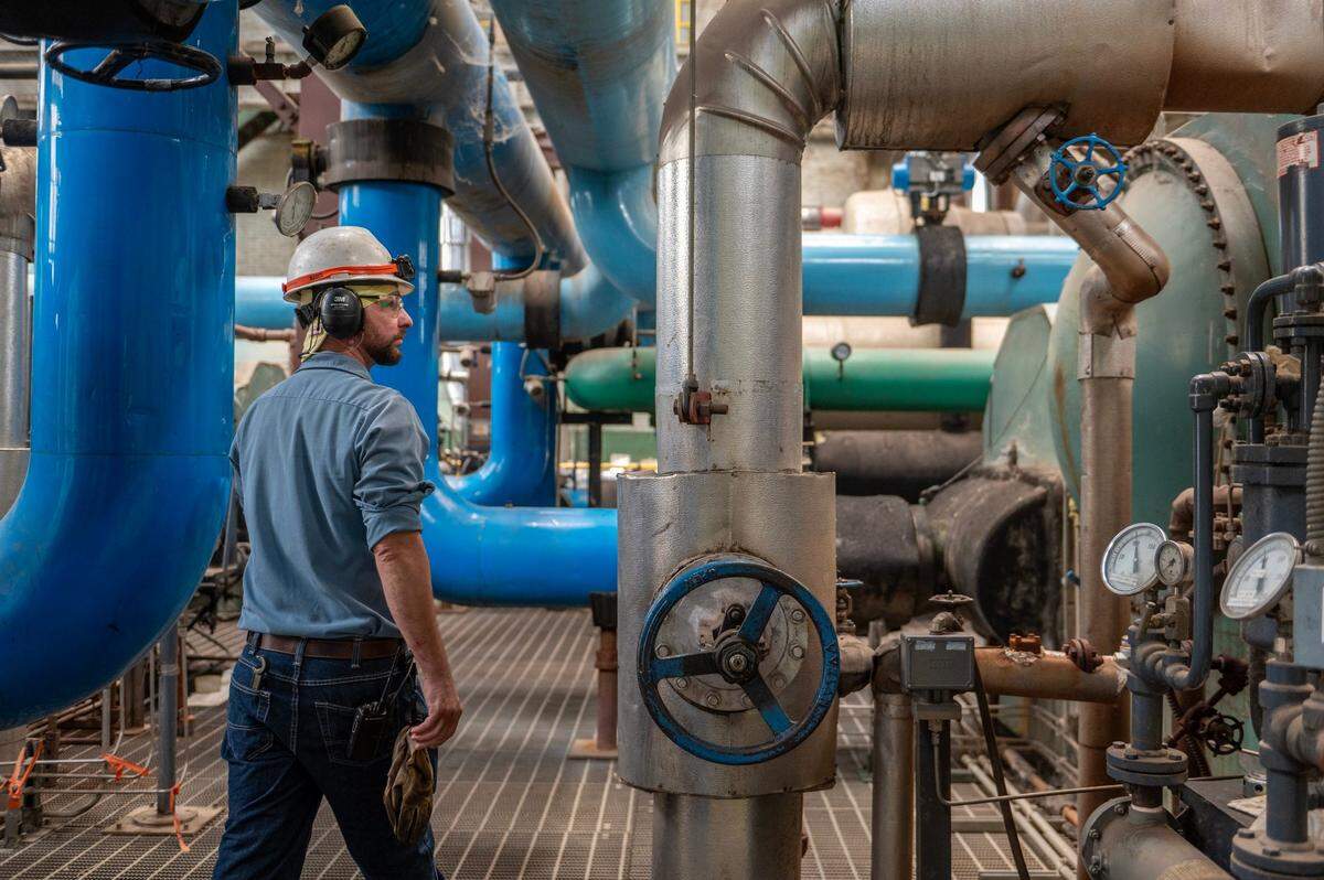 Aaron Waldrop, plant technician, inspects the maze of pipes on the chiller deck at the Vicinity Energy plant.