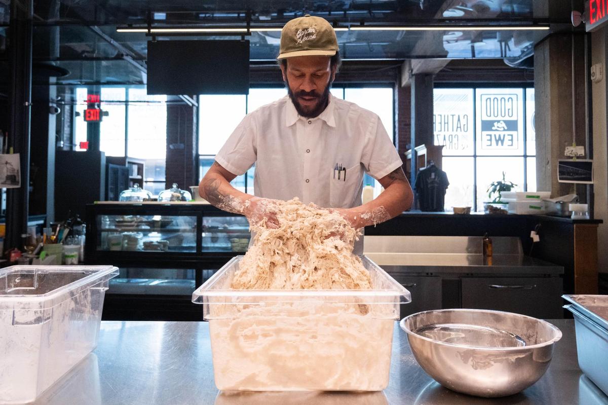 Kendall Harris, lead baker at Green Dirt on Oak, mixes a sourdough for baking on Tuesday. Egg shortages and price increases have forced bakers in Kansas City to adjust to cover costs of the crucial ingredient.