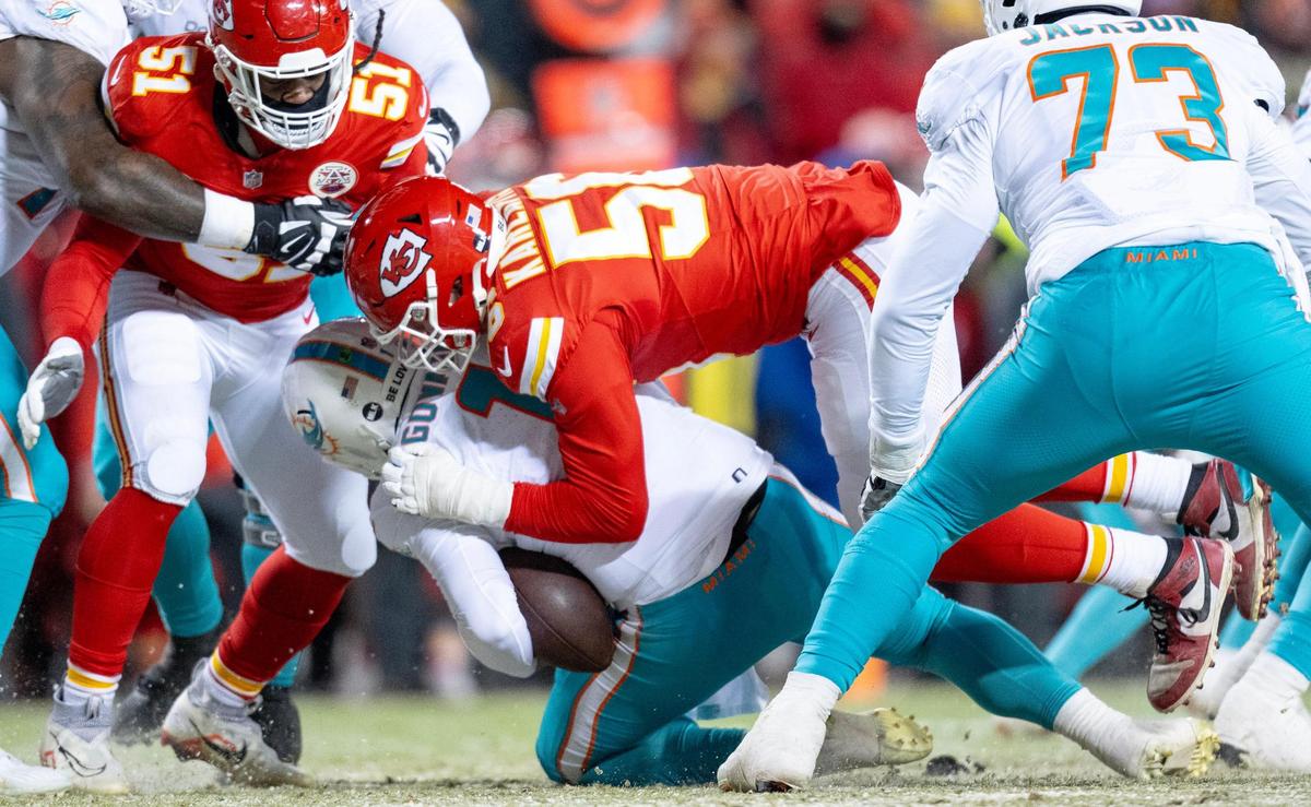 Kansas City Chiefs defensive end George Karlaftis (56) sacks Miami Dolphins quarterback Tua Tagovailoa (1) during an AFC Wild Card game at GEHA Field at Arrowhead Stadium on Saturday, Jan. 13, 2024, in Kansas City.