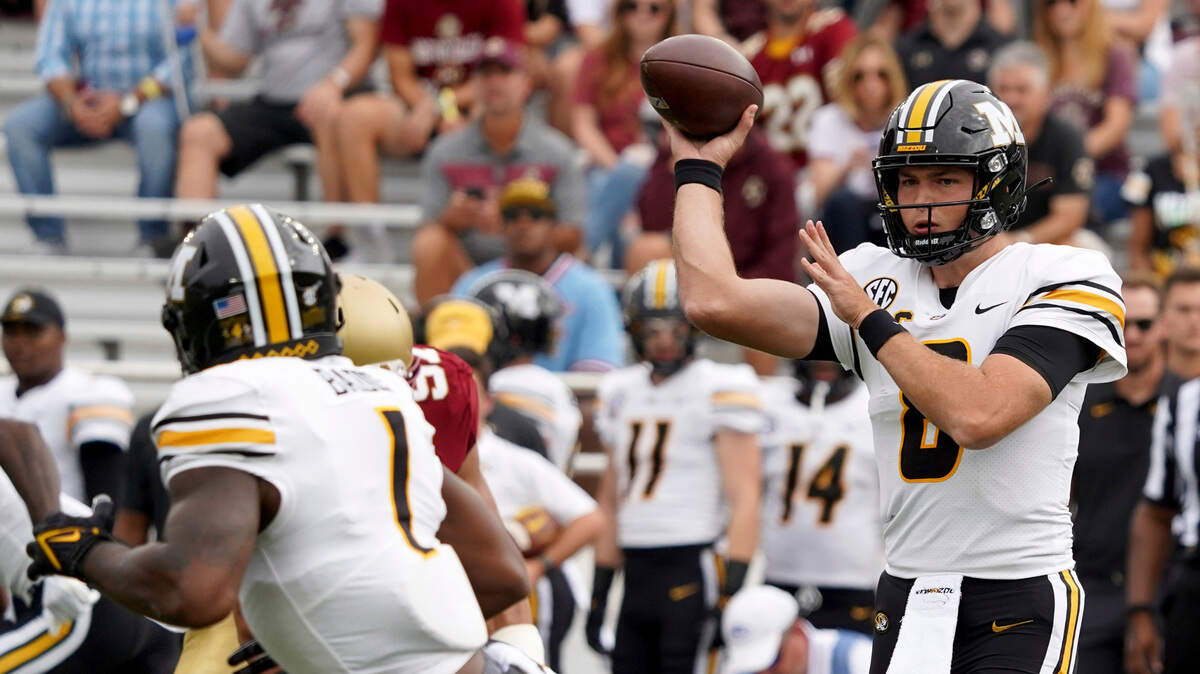 Missouri quarterback Connor Bazelak (8) passes to Tyler Badie (1) during the first half of an NCAA college football game against Boston College, Saturday, Sept. 25, 2021, in Boston. (AP Photo/Mary Schwalm)